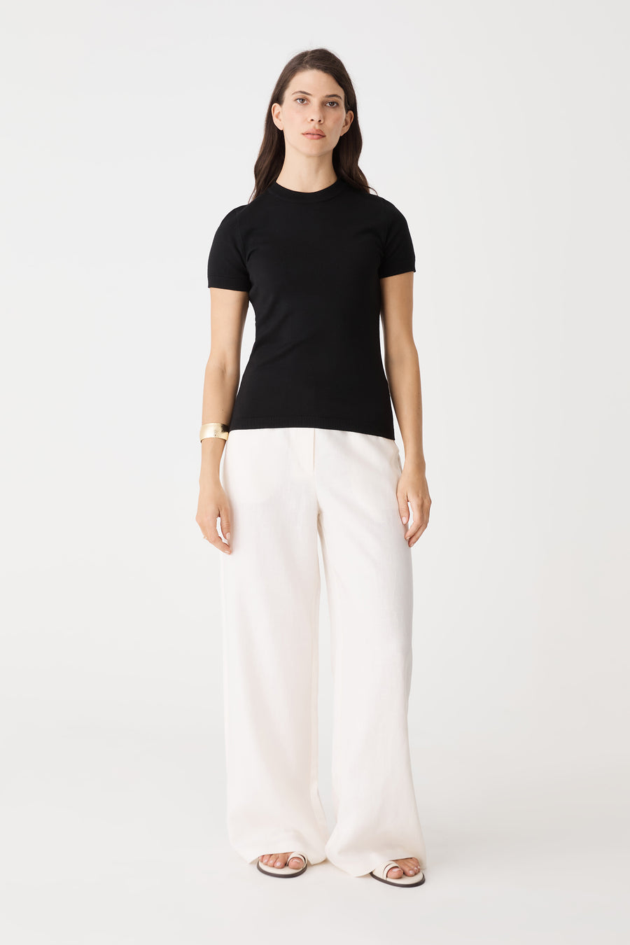 Catherine Short Sleeve Knit in black, front view worn with white wide-leg pants