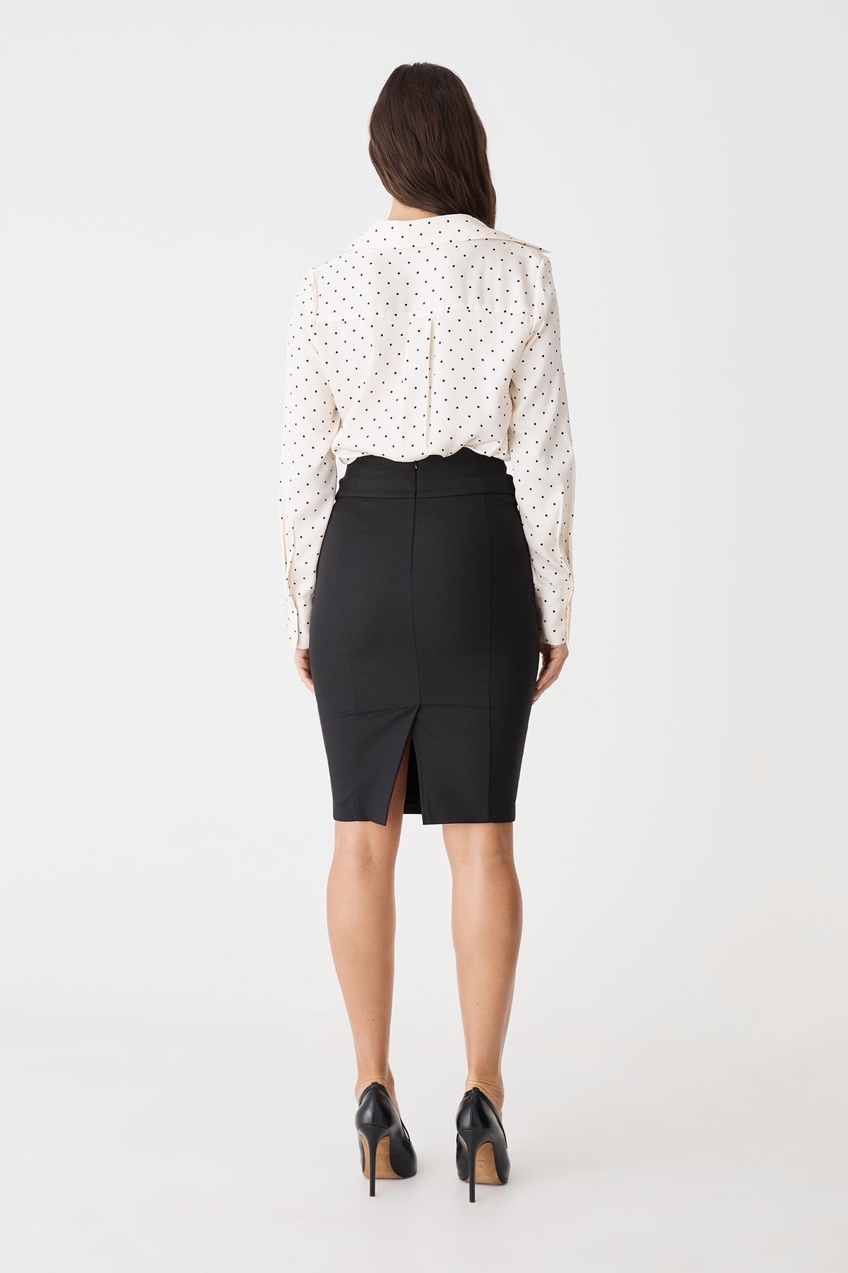 Back view showing centre back zipper and back vent of the black Safira Pencil Skirt
