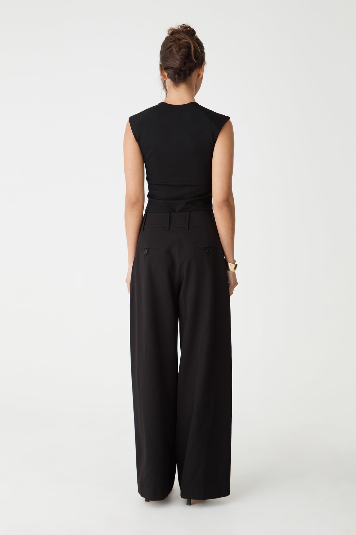 Back view of the black Soho Scoop Neck Top with black wide-leg pants