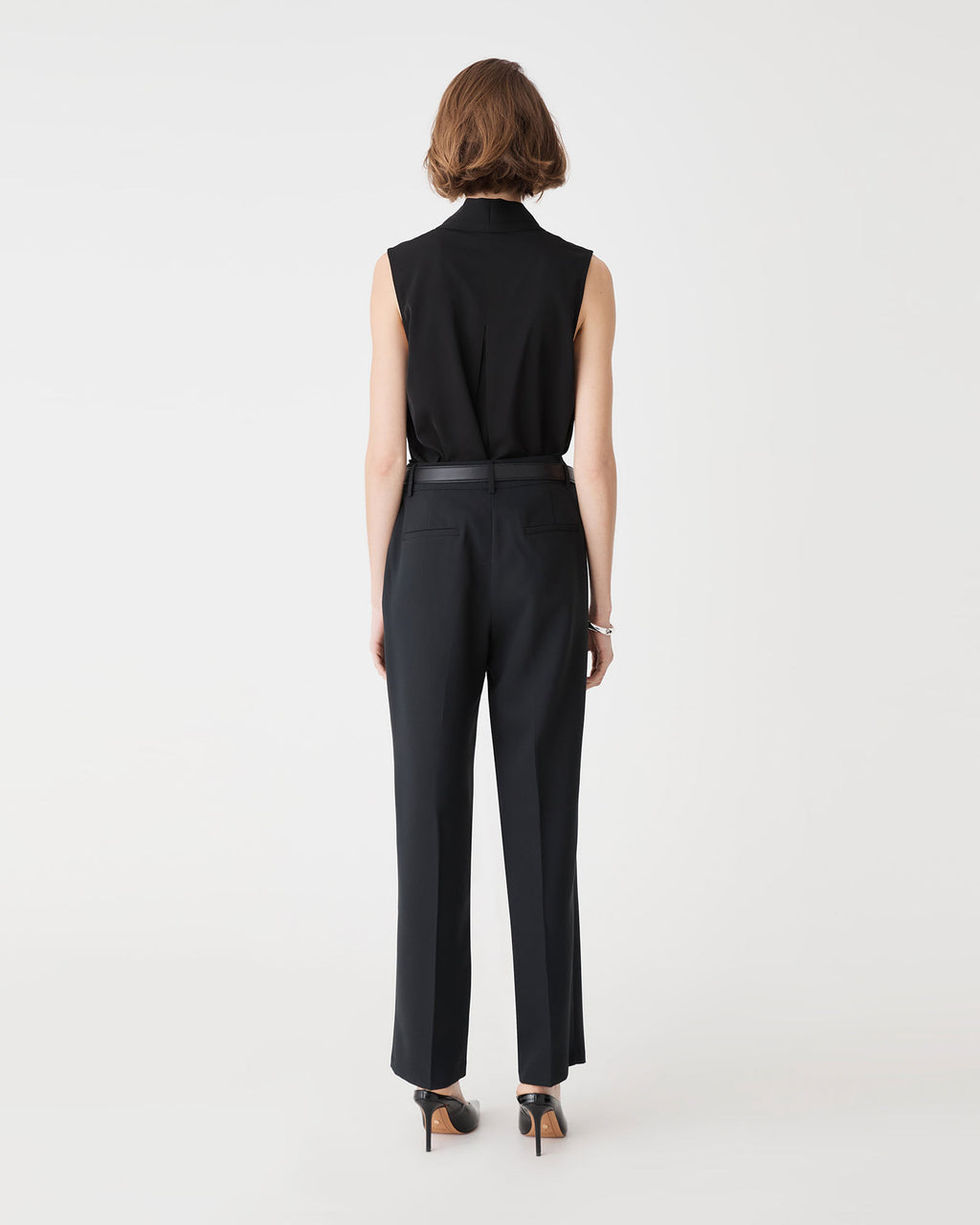 Back view of the black Alivia 2 V-Neck Top showing back tuck detail