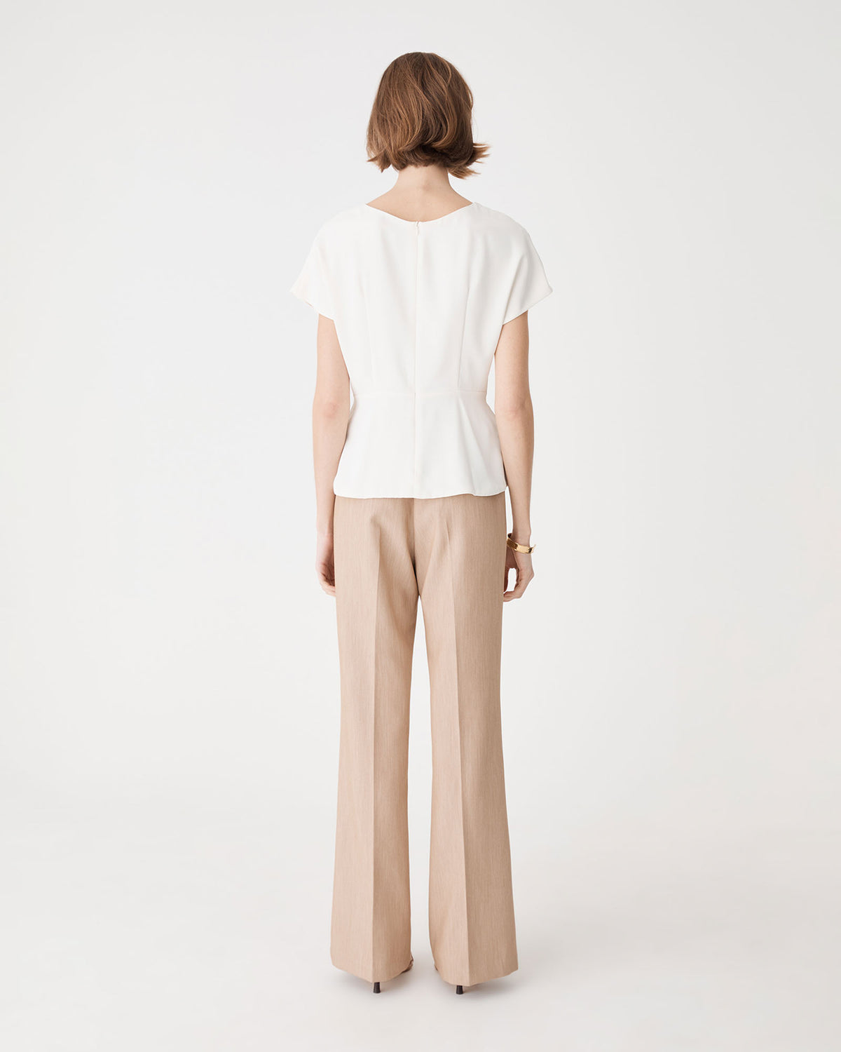 Bonnie Gathered Peplum Top in ivory — back view