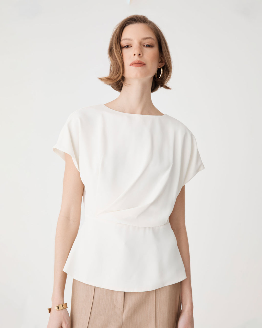 Bonnie Gathered Peplum Top in ivory — close-up view