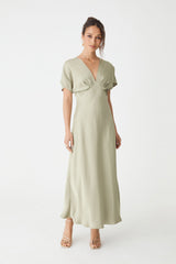 Catalina V-Neck Satin Dress in sage, front view with batwing sleeves and bias-cut midi skirt, worn with heels