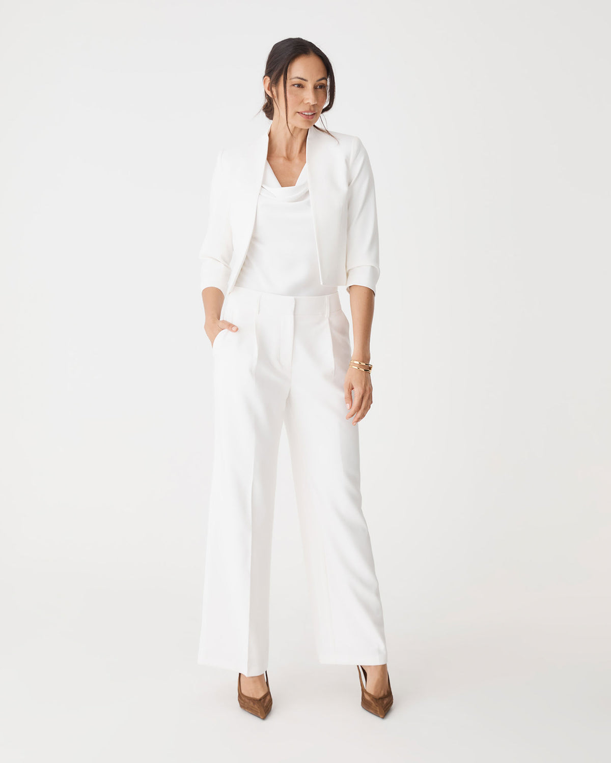 Front view of the ivory Nikki Tailored Pants worn with a matching ivory jacket