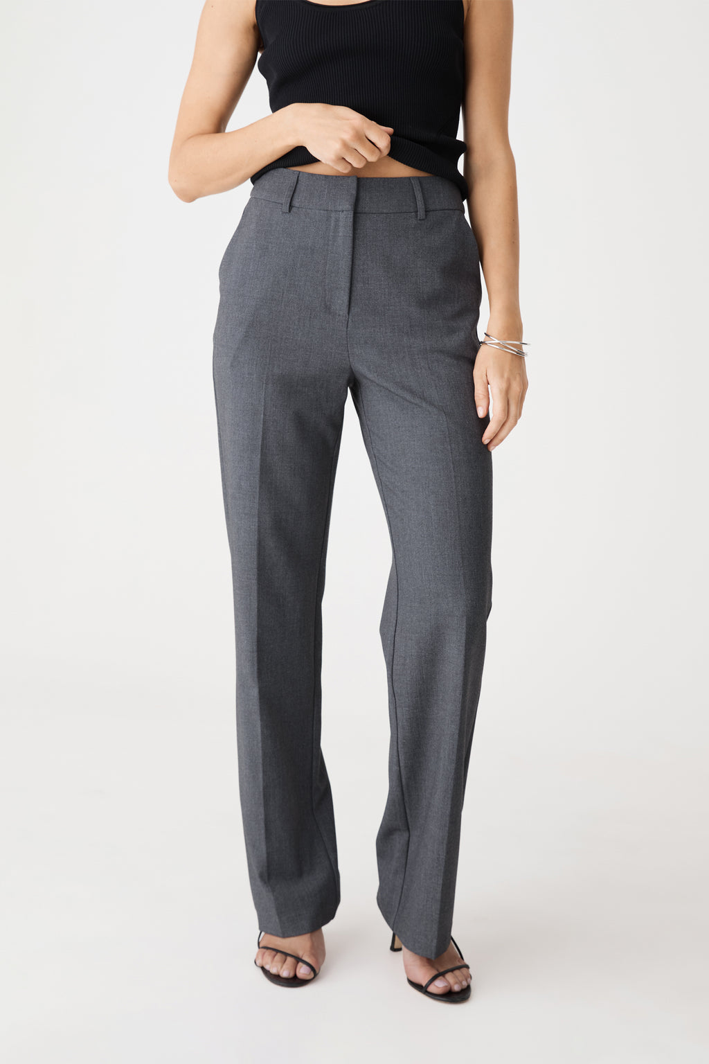 Front view of dark grey Merid Tailored Pants, straight leg, worn with black top