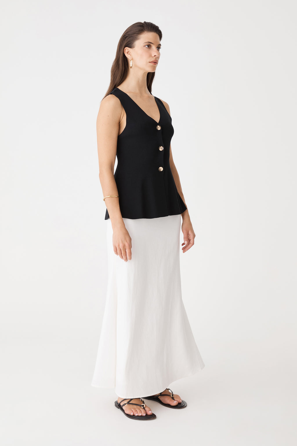 Side view of the ivory Amelia Linen Blend Maxi Skirt with black top