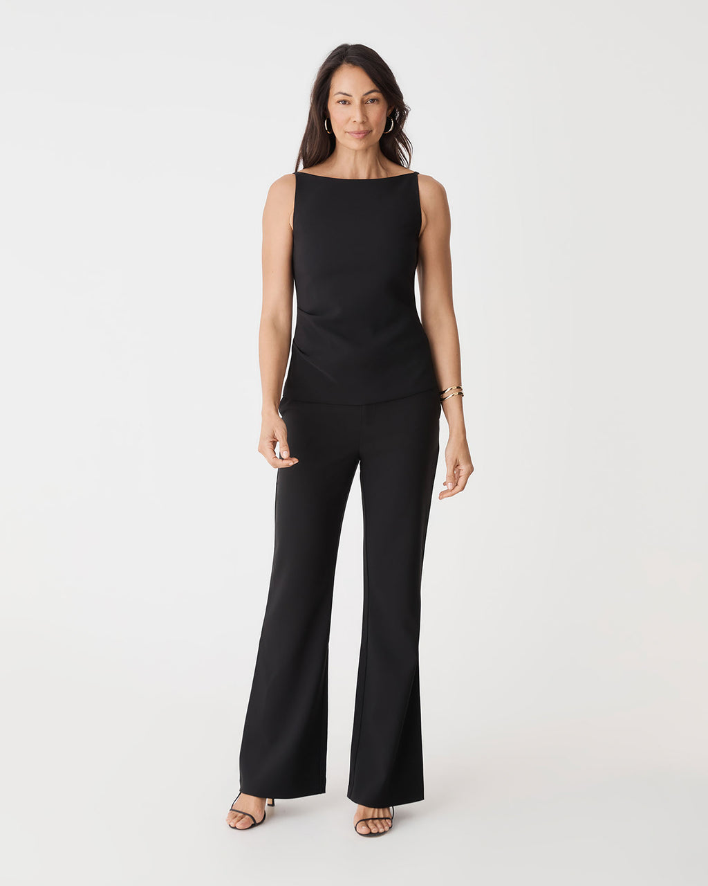 Hannah Apron Top in black, front view worn with matching black bootleg pants