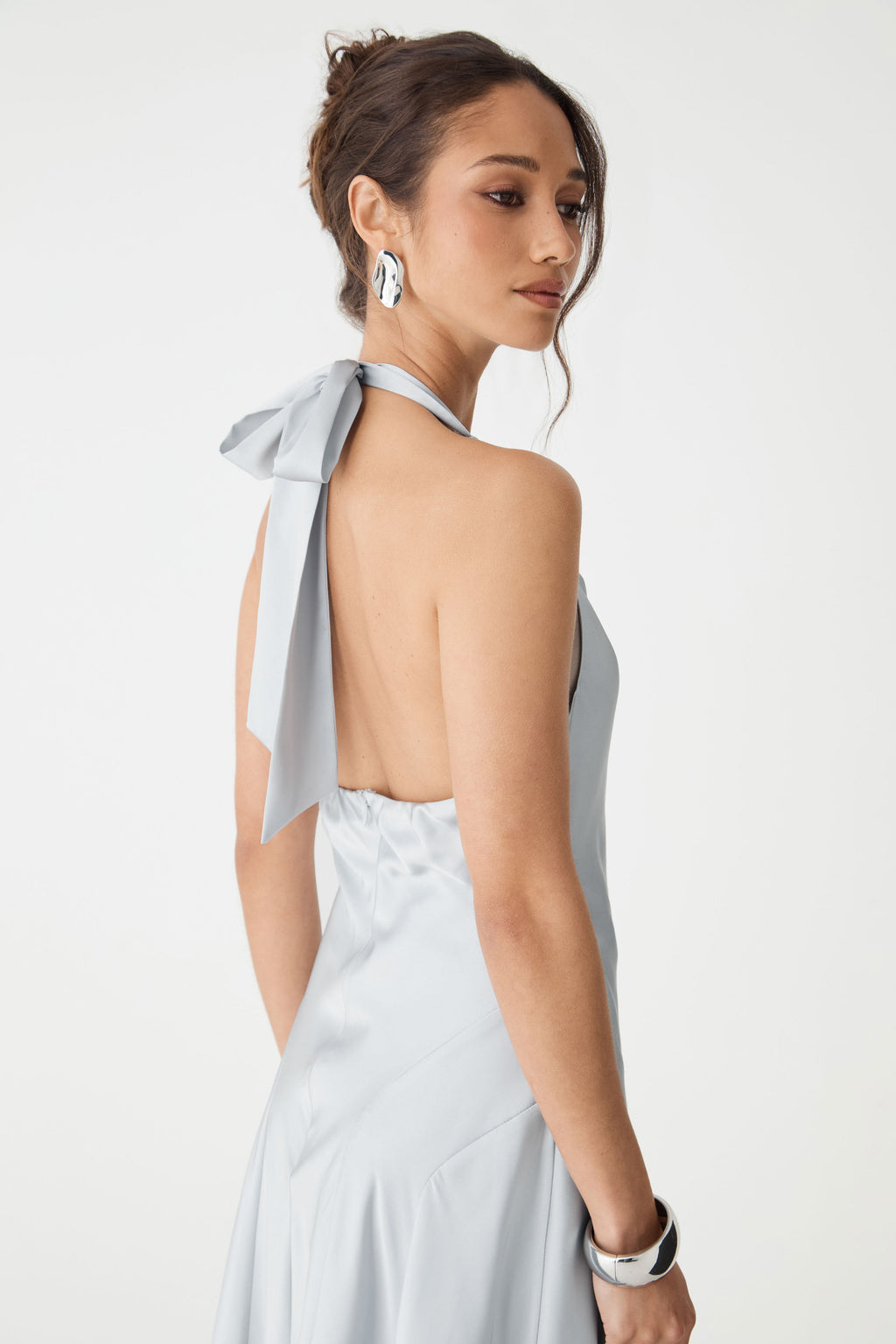 Close-up of the open back and halter tie bow in powder blue satin