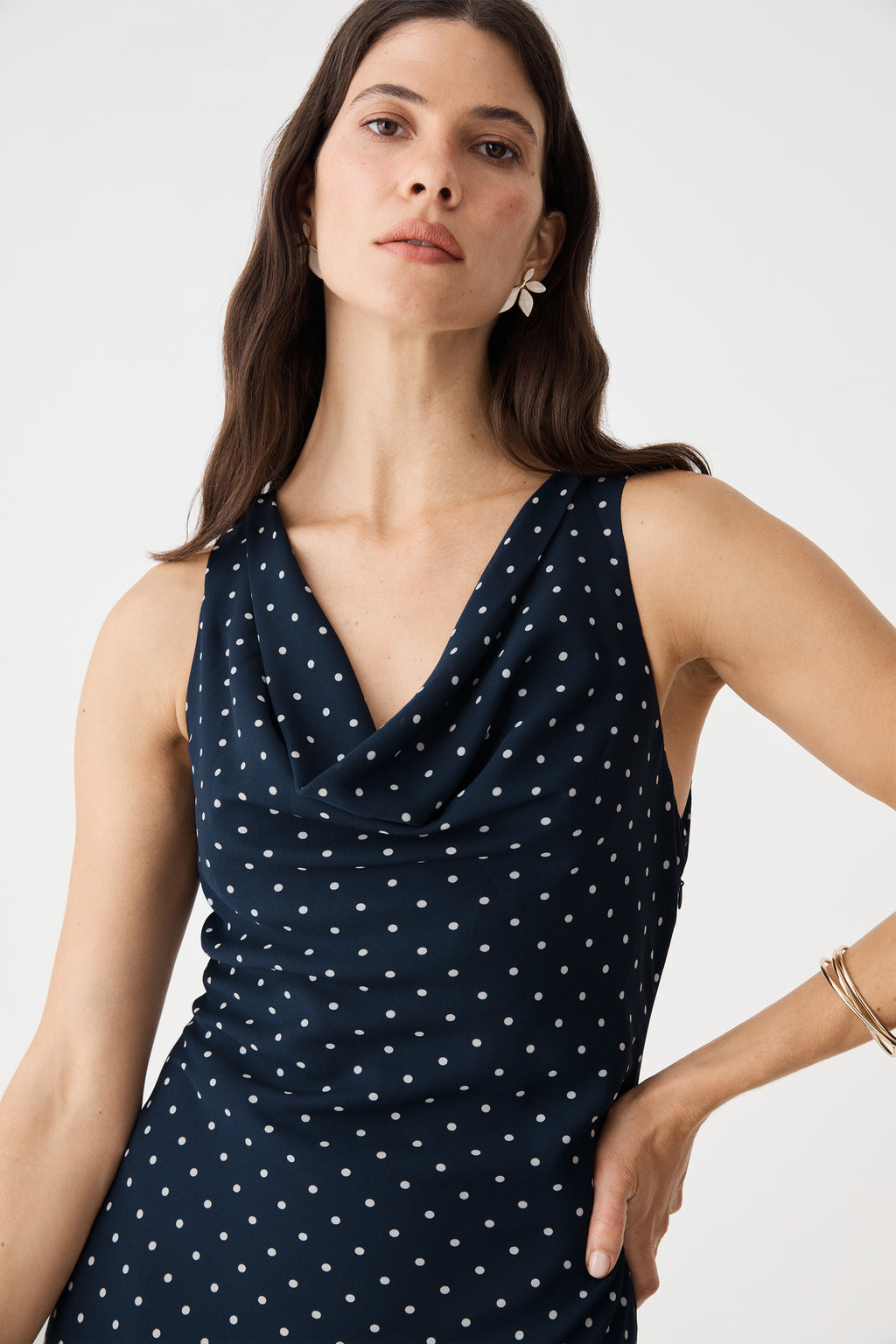 Close-up of the draped cowl neckline on the navy spot dress