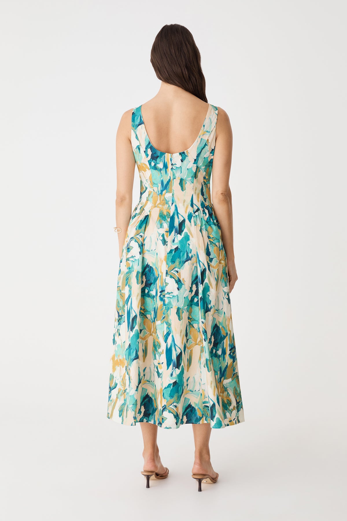 Back view showing the low scoop back and A-line midi skirt