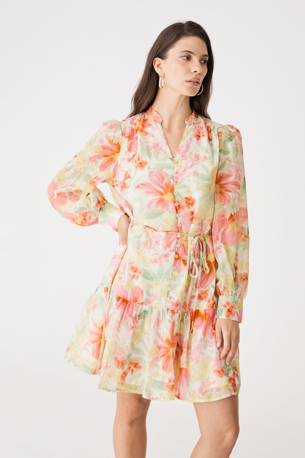 Three-quarter view showing button placket and waist tie of the pink floral dress