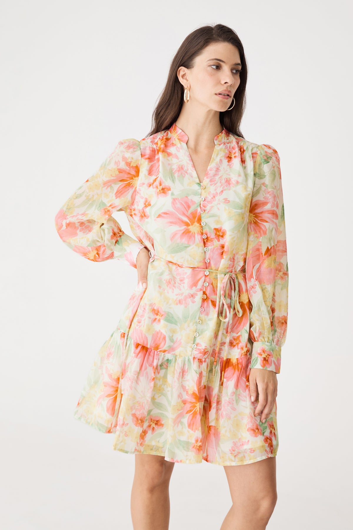 Three-quarter view showing button placket and waist tie of the pink floral dress