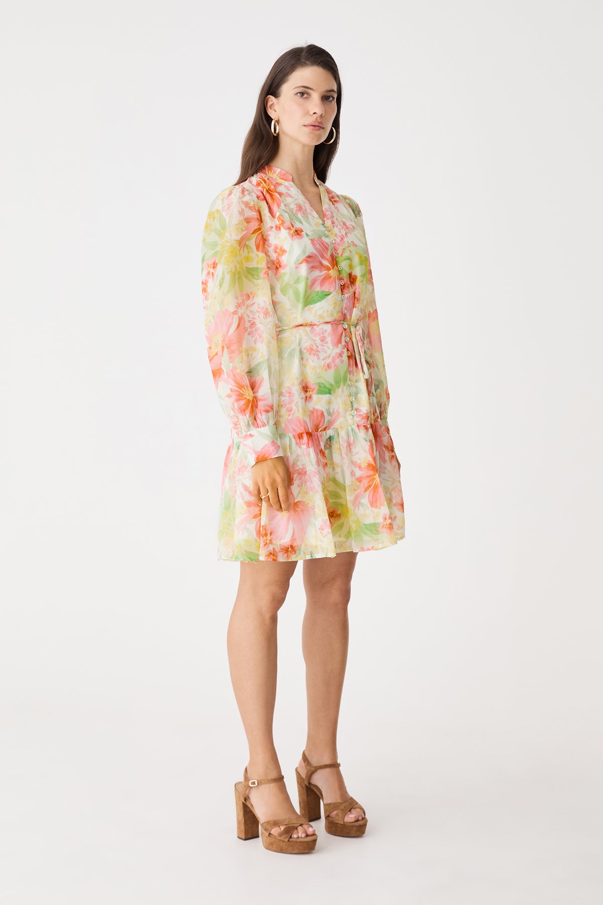 Side view showing blouson sleeves and tiered hem of the pink floral dress