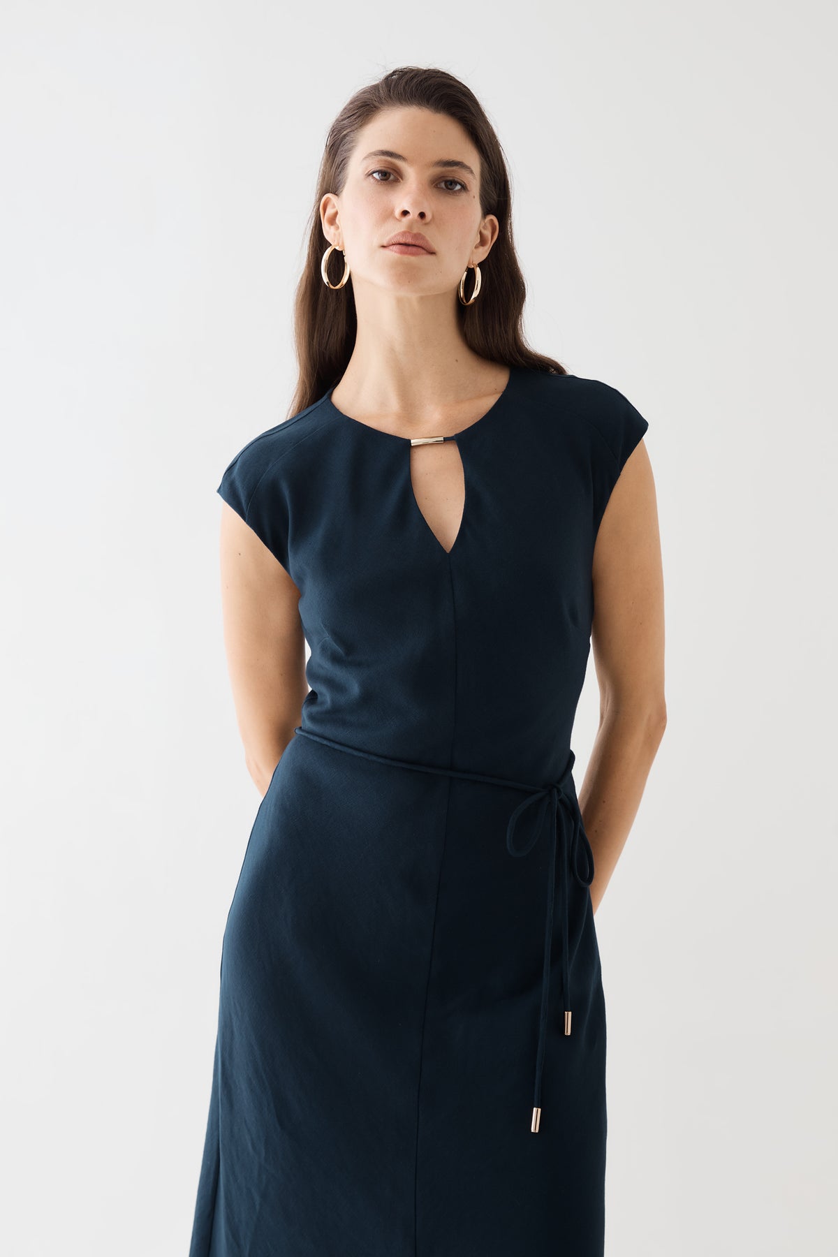 Close-up of the keyhole cut-out with gold-tone accent bar and belt ends