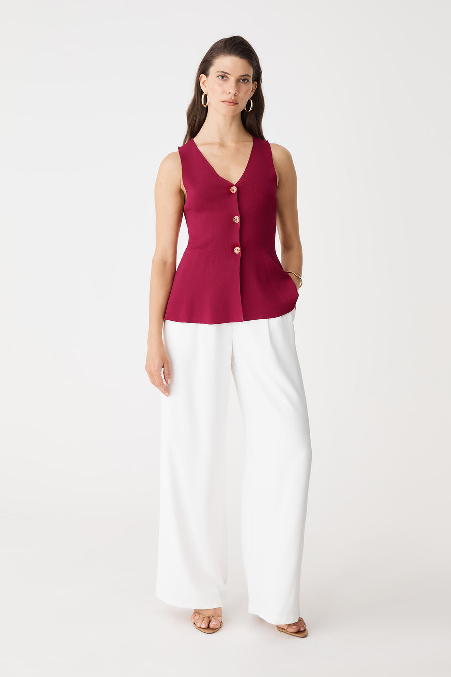 Valerie Button Peplum Knit Top in berry red, front view worn with white wide-leg trousers