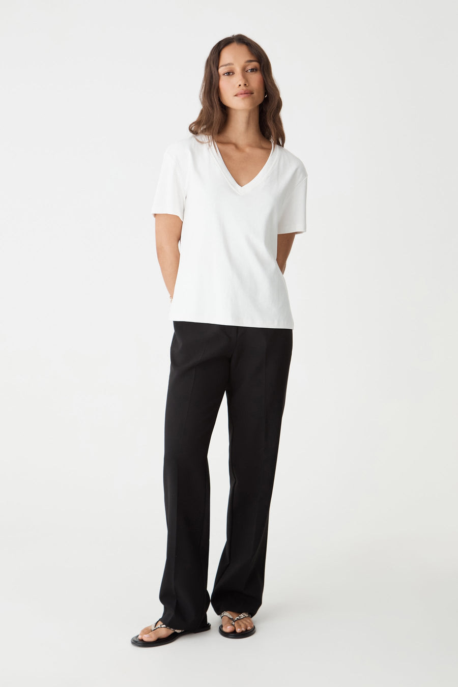 Nikki Mid Rise Straight Pants in black, front view worn with a white V-neck tee