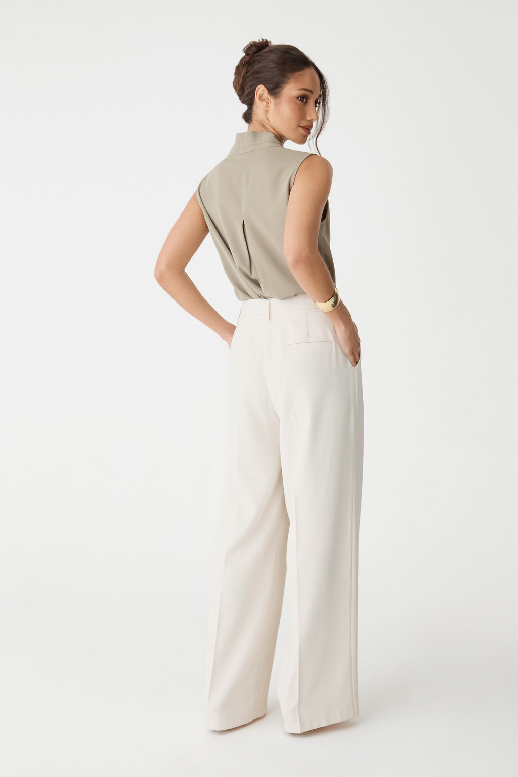 Back view of the cream wide-leg pants showing back welt pockets
