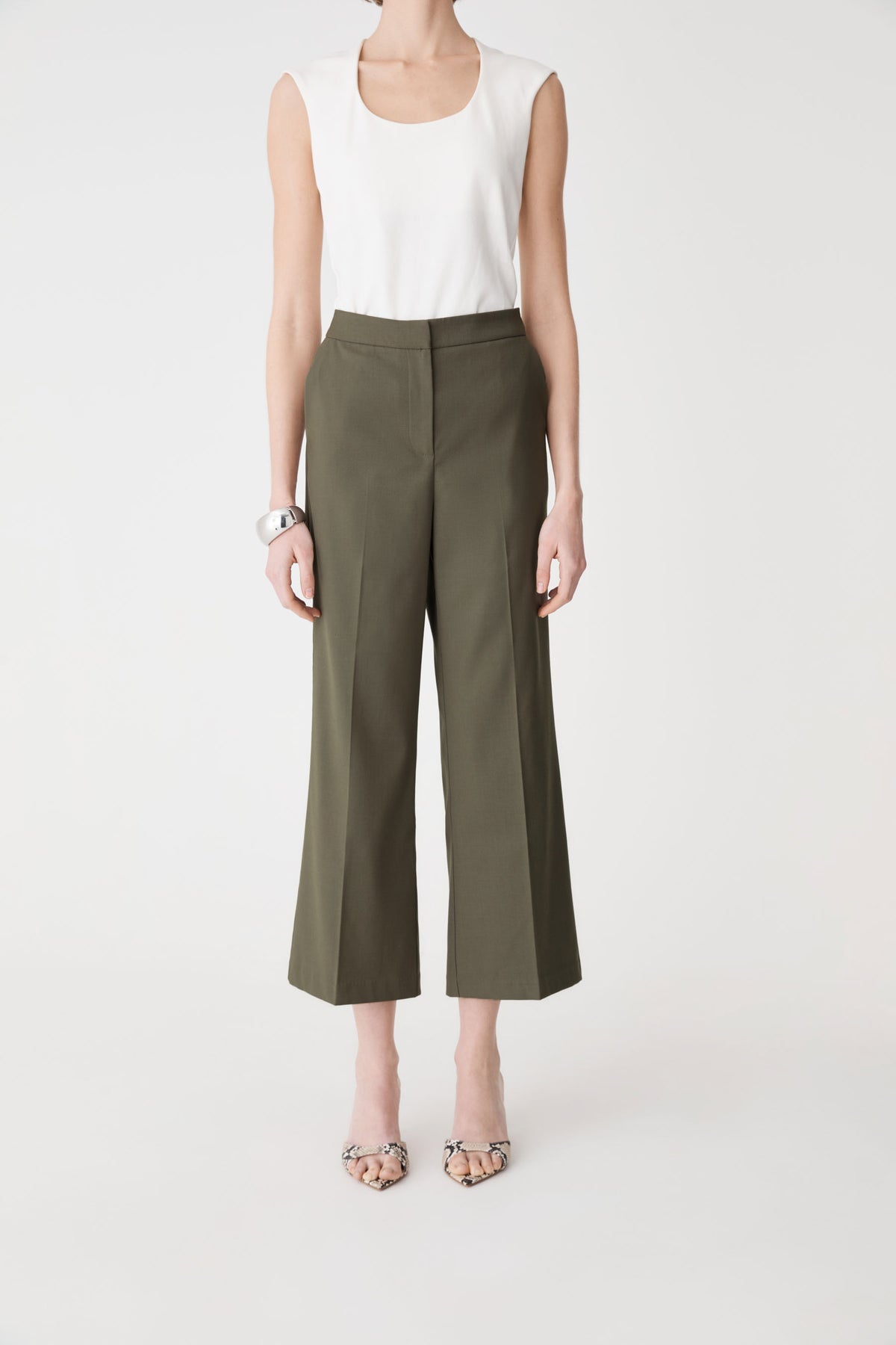 Milan Crop Flare Pants in olive, front view worn with a white sleeveless top
