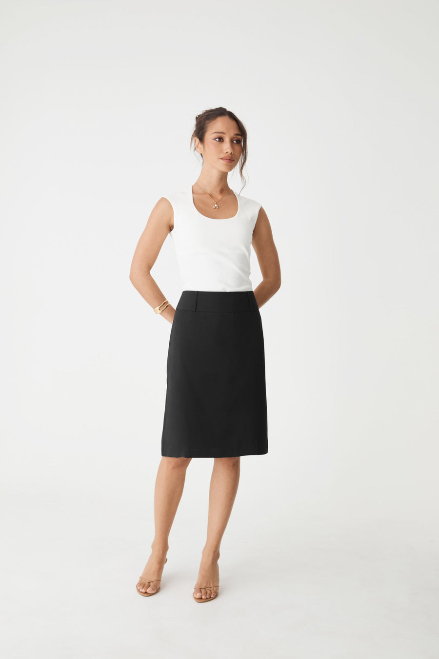 Veronica Straight Crepe Skirt in black, front view worn with a white sleeveless top