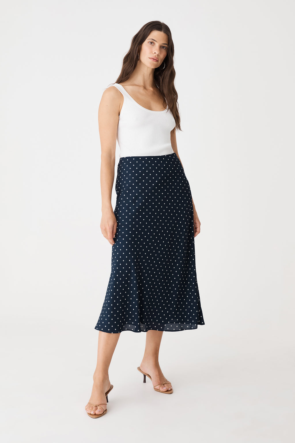 Side-front view of the navy spot A-line midi skirt