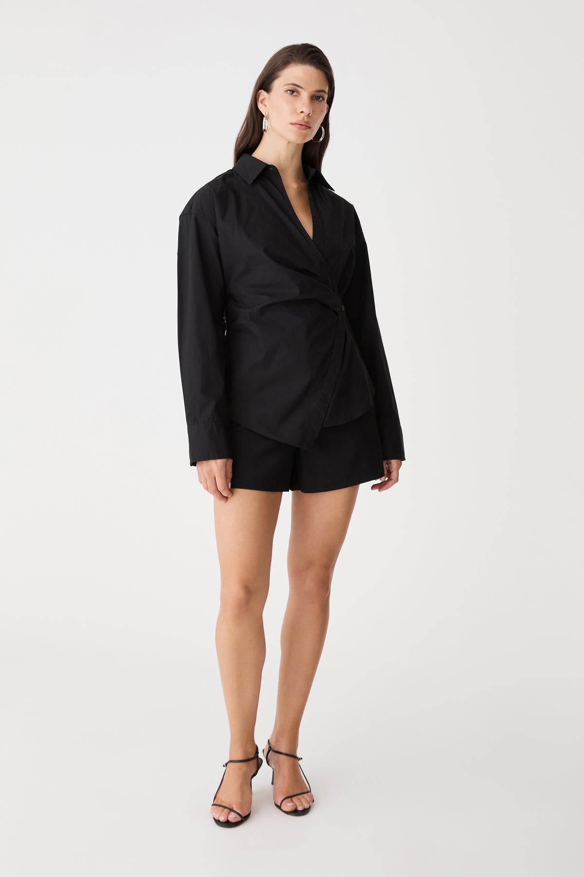 Front view of the black Katrina Wrap Shirt with long sleeves and dropped shoulders