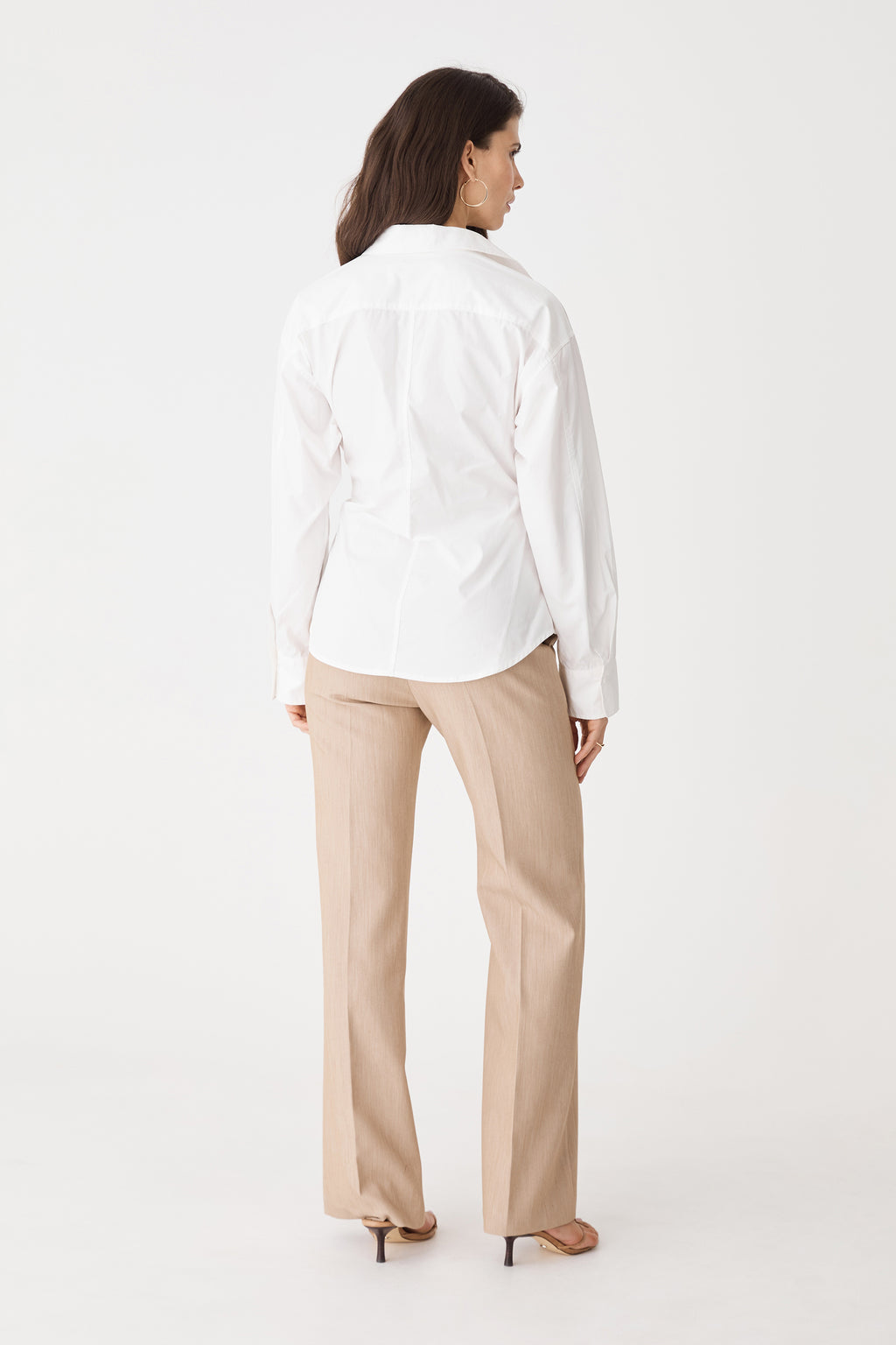 Back view of the ivory Katrina Wrap Shirt with beige trousers