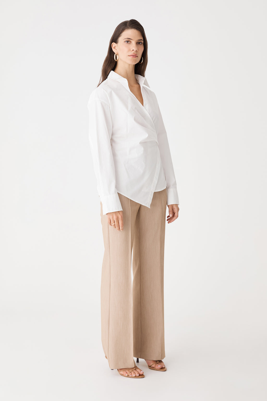 Side view of the ivory Katrina Wrap Shirt with beige trousers