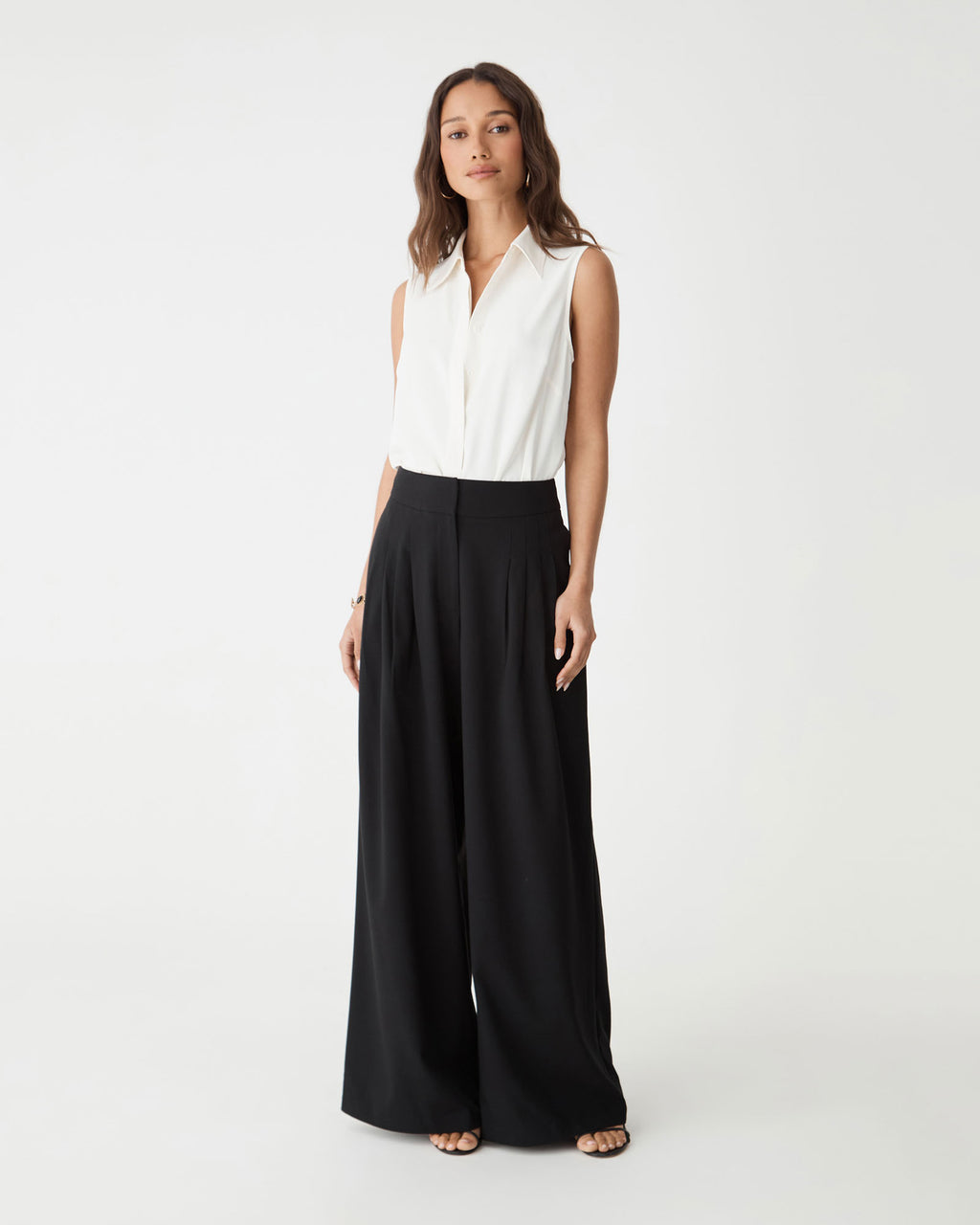 Brooklyn Sleeveless Shirt in ivory, front view worn with black wide-leg trousers
