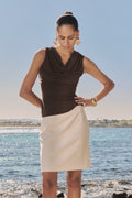 Shayna Bamboo Cowl Top in Fudge worn with a cream skirt outdoors, front view