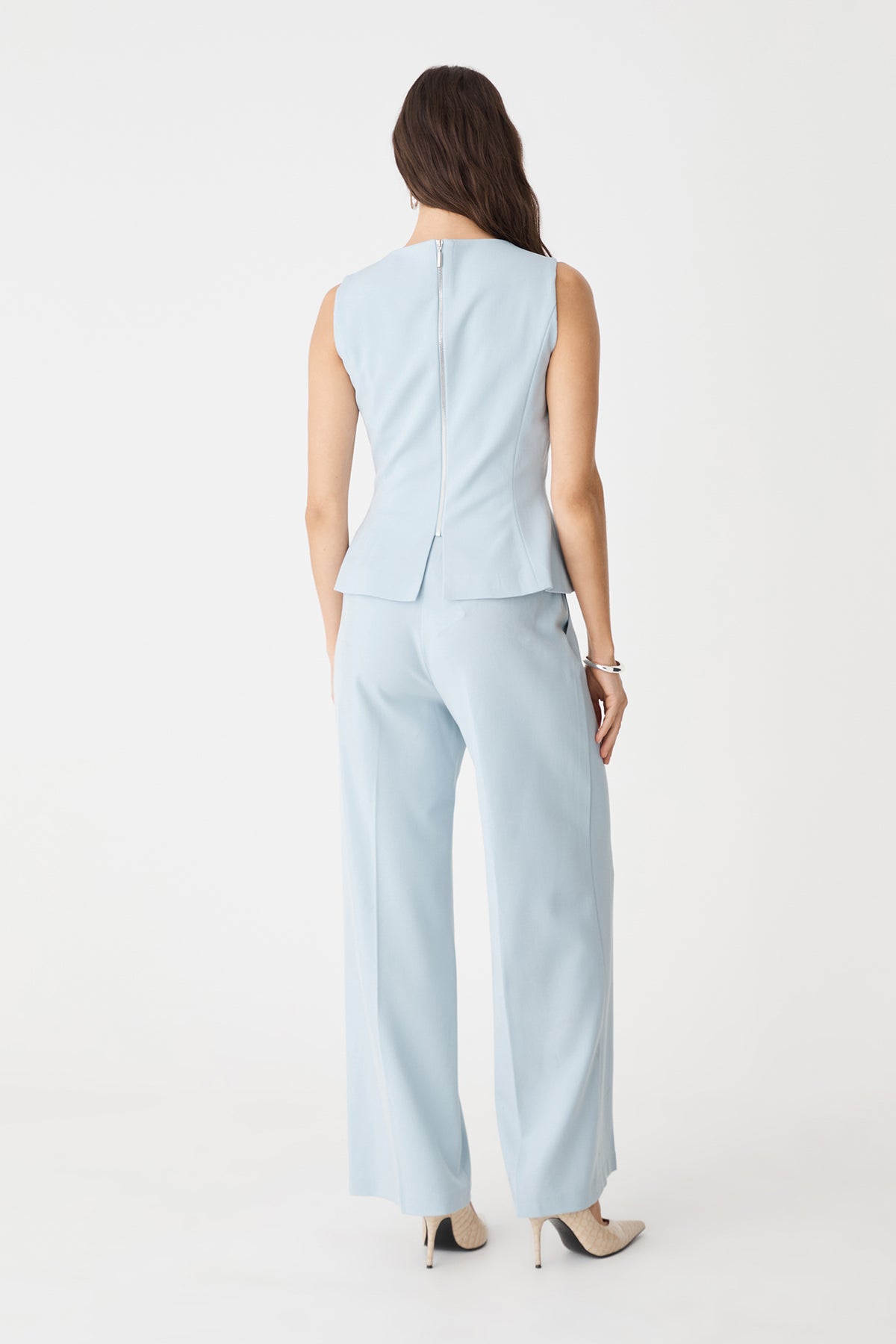 Back view showing the exposed silver-tone zip of the sky blue Melanie Tailored Top