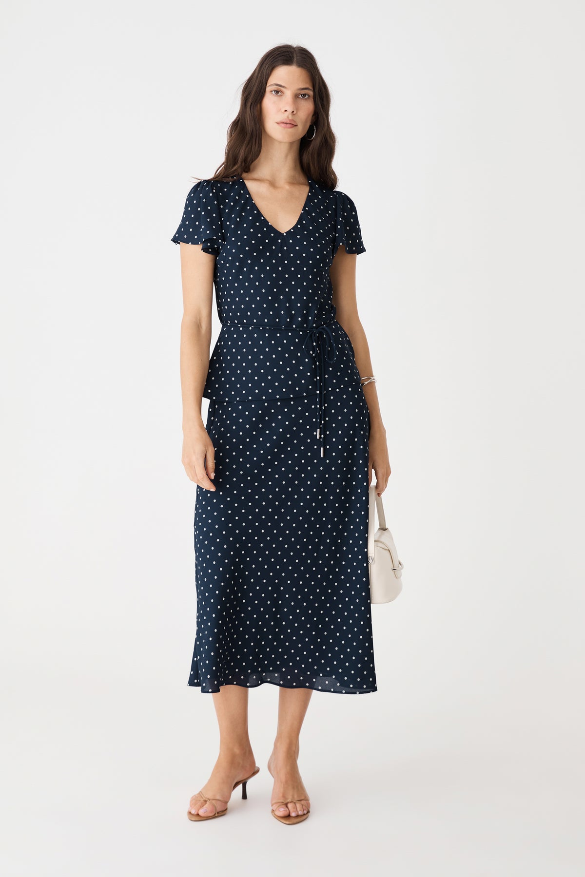 Danielle Frill Sleeve Top in Navy Spot, front view worn with matching polka dot midi skirt and tie belt