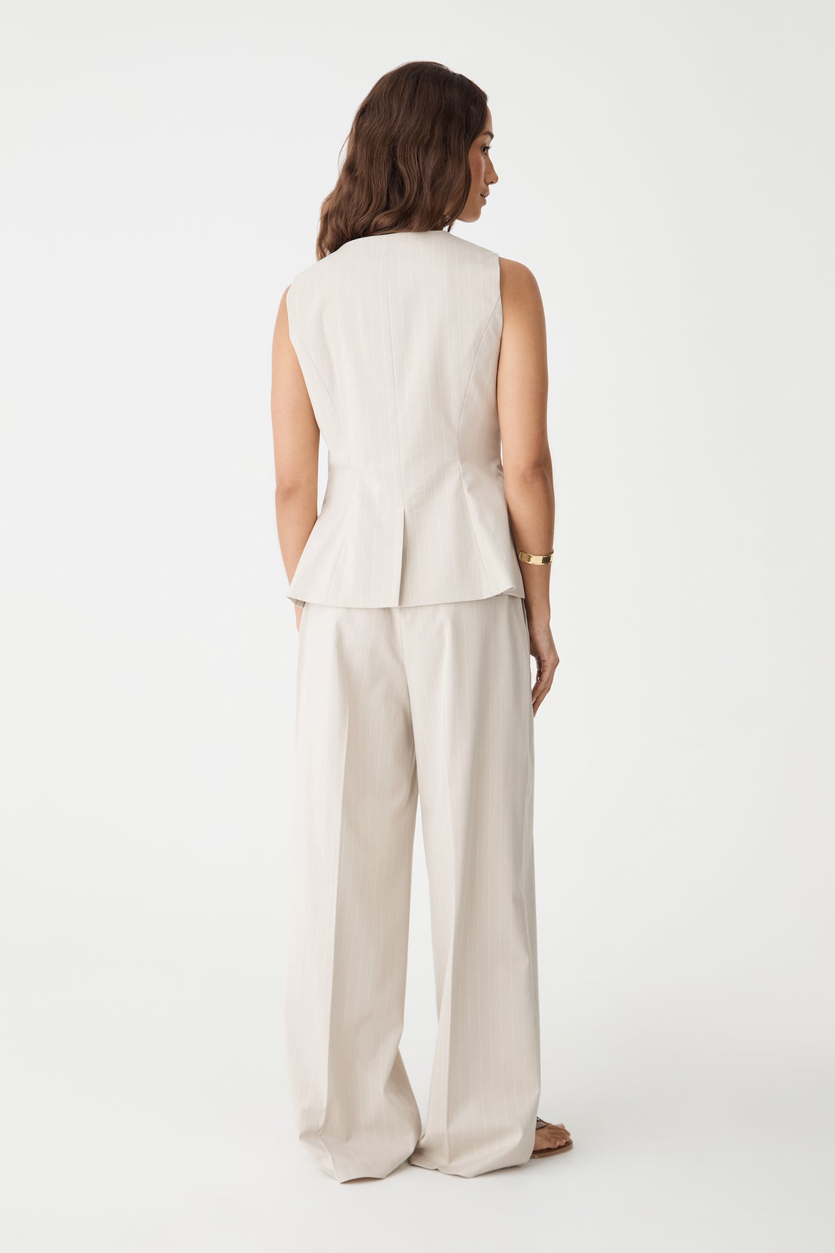 Back view of the Zoe Pinstripe Vest in beige pinstripe