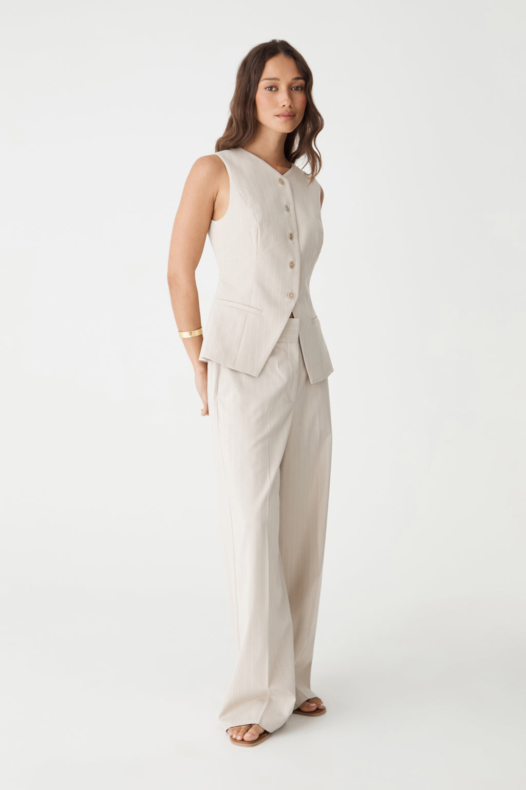 Side view of the Zoe Pinstripe Vest in beige pinstripe