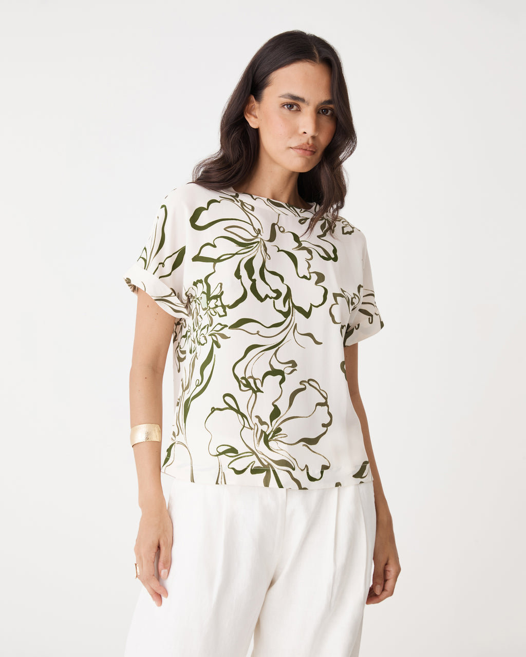 Close-up front view of the cream and olive floral print and round neckline