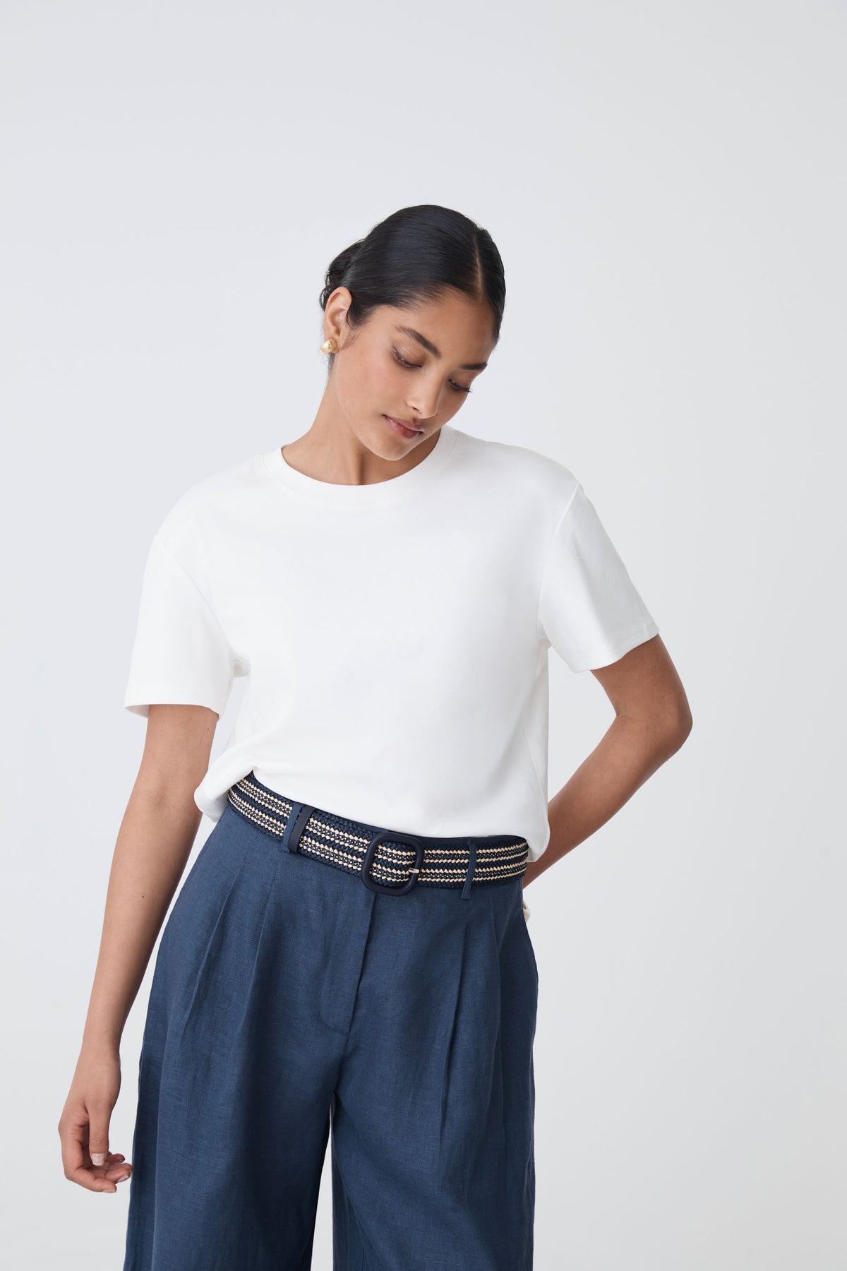 Maya Braid Belt in black and cream worn at the waist, front view