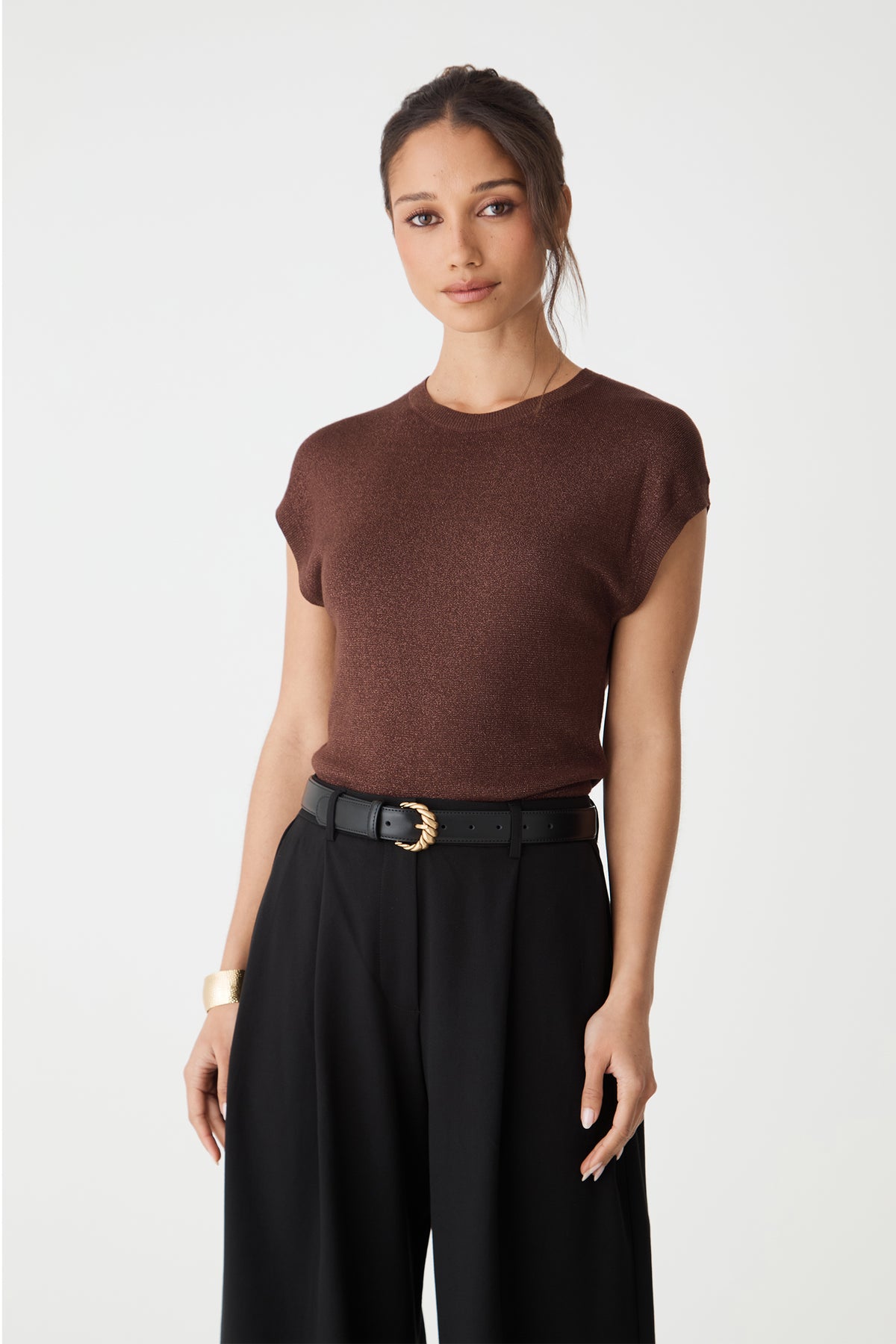 Empire Leather Belt in black worn at the waist, angled view showing the strap and keeper loop