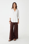 Ami Linen Elastic Back Pants in dark chocolate, front view, worn with a white linen shirt