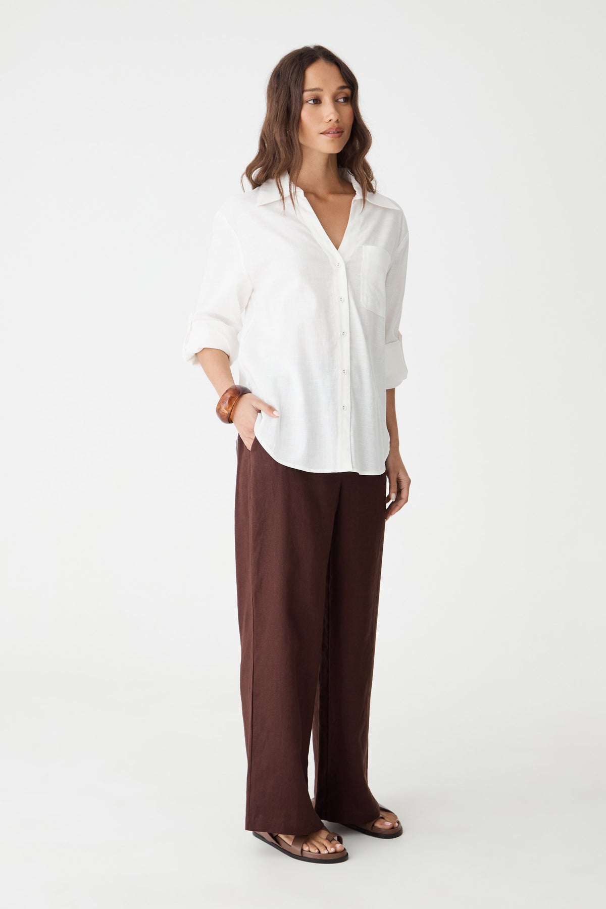 Side view of the dark chocolate wide-leg linen pants with white shirt